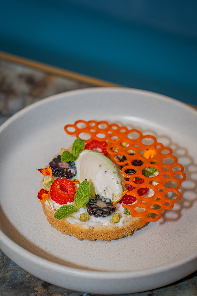 A plated dessert with berries at Desi Lounge